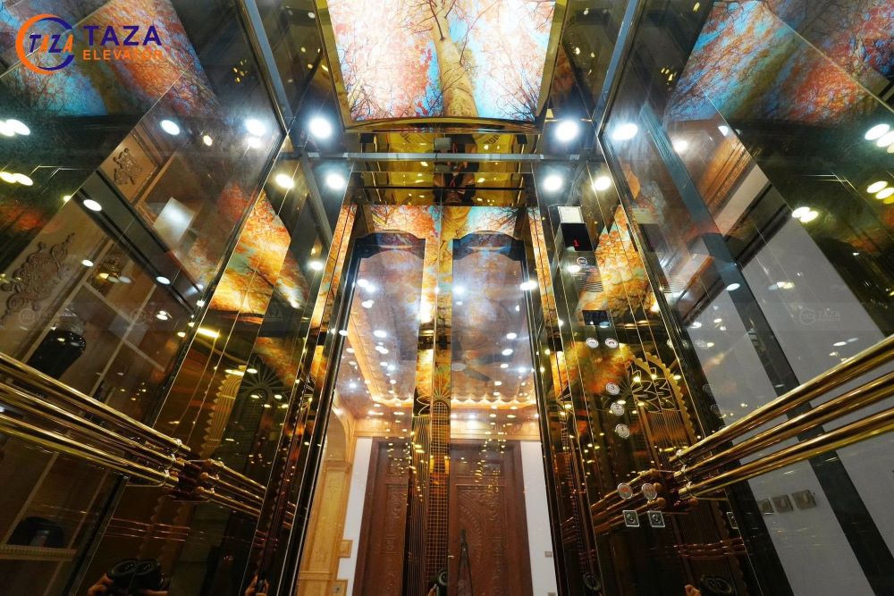 Bàn giao thang máy kính inox gương vàng cho biệt thự tân cổ điển