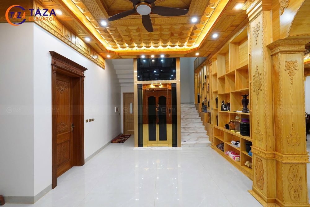 Bàn giao thang máy kính inox gương vàng cho biệt thự tân cổ điển