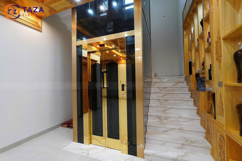 Bàn giao thang máy kính inox gương vàng cho biệt thự tân cổ điển