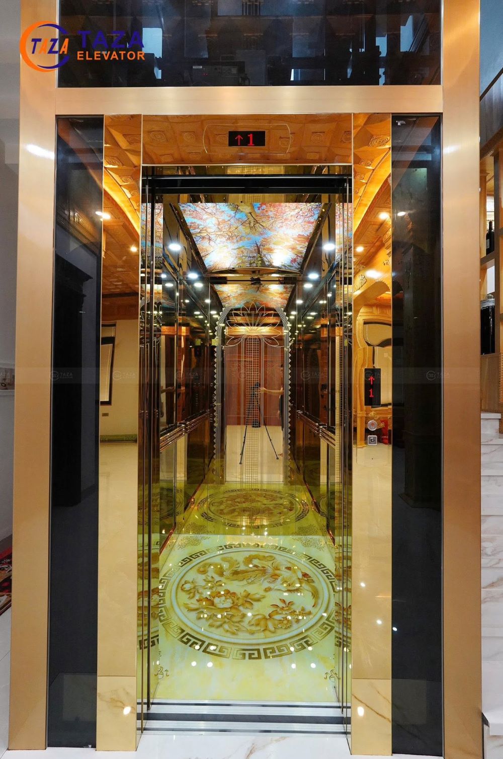 Bàn giao thang máy kính inox gương vàng cho biệt thự tân cổ điển